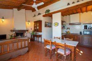 a kitchen with a table and chairs and a fireplace at Agriturismo Luggiano in Vinci