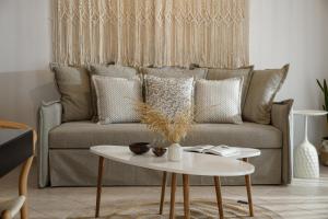 a living room with a couch and a table at Villa Irina in Agios Prokopios +33 photos