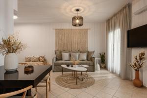 a living room with a couch and a table at Villa Irina in Agios Prokopios