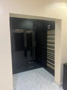 a room with black cabinets in a building at ifetomitola in Iseri-Osun