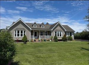 a house with a large yard with green grass at NinaOCPlace in Ocean City