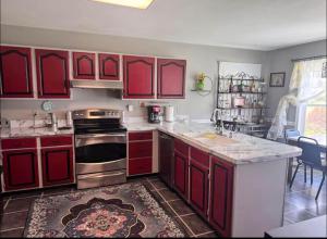 a kitchen with red cabinets and a counter top at NinaOCPlace in Ocean City
