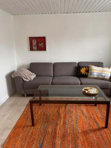a living room with a couch and a coffee table at Villa With Three Bedrooms in Vemb
