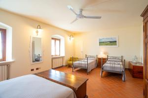 a bedroom with two beds and a ceiling fan at Agriturismo Luggiano in Vinci +49 photos