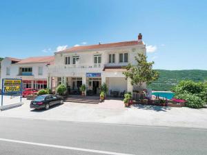 a house with a car parked in front of it at Hotel Villa Matic in Neum