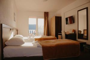 a hotel room with two beds and a window at Hotel Villa Matic in Neum +88 photos