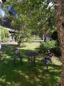a table and two chairs sitting in the grass at Molly and Butter in Valmiera