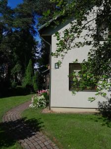a house with a window and a brick driveway at Molly and Butter in Valmiera