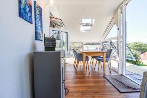 a kitchen and dining room with a table and chairs at Coombe Lodge No 9 in Bude