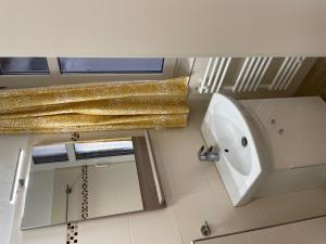 a bathroom with a sink and a toilet and a mirror at Haus Roland, Wohnung 16 in Zinnowitz +7 photos