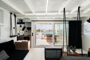 a living room with a view of the ocean at Captain Zeppos in Pollonia