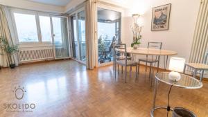a living room with a table and chairs at Apartment house Lötschberg in Naters