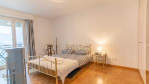 a bedroom with a bed and a large window at Apartment house Lötschberg in Naters