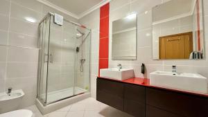 a bathroom with two sinks and a shower at Santa Maria N - Shared Pool - 8 Guests - Albufeira in Albufeira