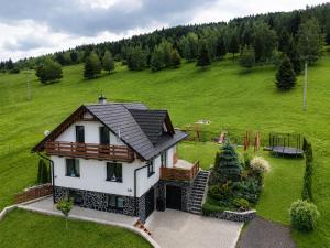 an aerial view of a house in a green field at Chata Lomňanka in Lomná
