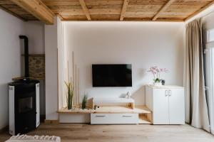 a living room with a tv on a white wall at La cochera by Óscar Fuentes in Alcocer de Planes