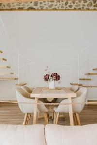 a dining room with a table and chairs at La cochera by Óscar Fuentes in Alcocer de Planes +3 photos