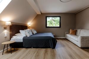 a bedroom with a bed and a couch at Willa Karla in Krynica Zdrój