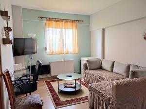 a living room with a couch and a table at GiannisHouse in Florina