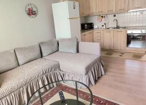 a living room with a couch and a kitchen at GiannisHouse in Florina