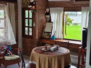 a living room with a table and a window at Darins House in Nan