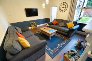 a living room with a couch and a table at Family Friendly I Pets Welcome I Short Walk to Railway Station I 10min Drive to Safari Park in Kidderminster