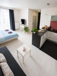 a kitchen and a living room with a couch and a table at RUMAKO apartments in Prague