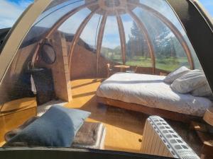 a room with two beds and a large window at Bulle insolite Wigwam in Aulnay-sur-Iton