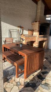 a wooden bench sitting in front of a brick oven at Ramboia Guest House in São Pedro do Sul