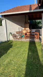 a picnic table and a bench under a porch at Ramboia Guest House in São Pedro do Sul