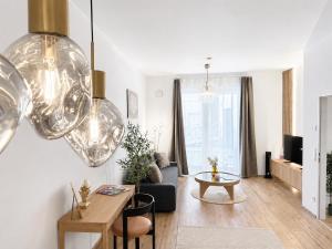 a living room with a couch and a table at Cosy Penzing Vienna in Vienna