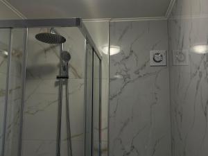 a bathroom with a shower with a glass door at Apartments Roncevic #JOKO# in Gradac +22 photos