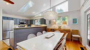 a kitchen with a table and chairs and a refrigerator at Dewey Beach 102 Jersey St in Dewey Beach