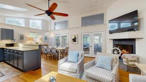 a kitchen and living room with a ceiling fan at Dewey Beach 102 Jersey St in Dewey Beach
