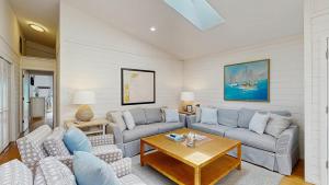 a living room with two couches and a table at Dewey Beach 102 Jersey St in Dewey Beach +16 photos