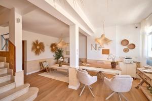 a living room with white walls and a table and chairs at INNER Niza Paguera in Paguera
