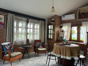 a living room with a table and chairs and windows at Darins House in Nan