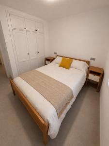 a bedroom with a large bed with a yellow pillow at Los cántaros Apartamento Mojácar in Mojácar +10 photos