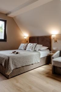 a bedroom with a large bed and a window at Willa Karla in Krynica Zdrój