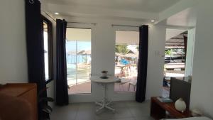 a room with windows and a view of a patio at Anchor Doods in Romblon +3 photos