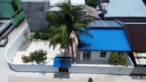 an overhead view of a building with a palm tree at Reethi Stay Omadhoo in Reethi Rah