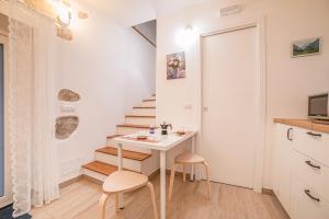 a small room with a table and a staircase at Appartamenti Monte Selce in Monselice