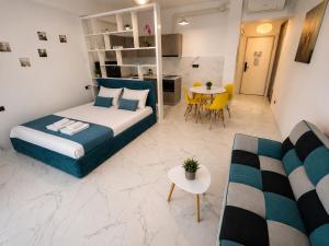 a bedroom with a bed and a living room at Studio Sea On Beach in Mamaia