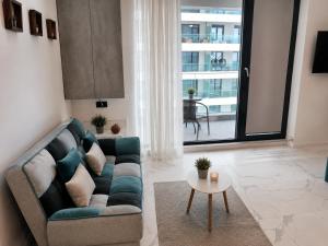a living room with a couch and a table at Studio Sea On Beach in Mamaia