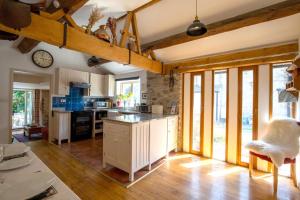 a large kitchen with wooden floors and a clock on the wall at The Forge in Bakewell