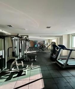 a gym with treadmills and machines in a room at WestFlat - Barreto 206 in Mossoró