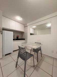 a kitchen with a table and chairs in a room at WestFlat - Barreto 206 in Mossoró