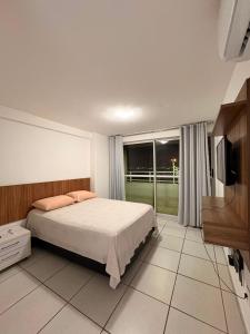 a bedroom with a bed and a large window at WestFlat - Barreto 206 in Mossoró +10 photos