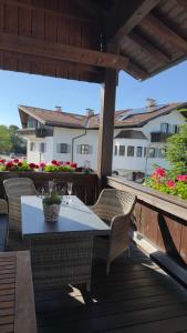 a patio with a table and chairs on a deck at Ferienwohnungen Irmengard in Bernau am Chiemsee