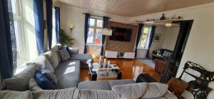 a living room with a couch and a table at Boat Included, Waterfront Villa, Near Bergen in Lindås